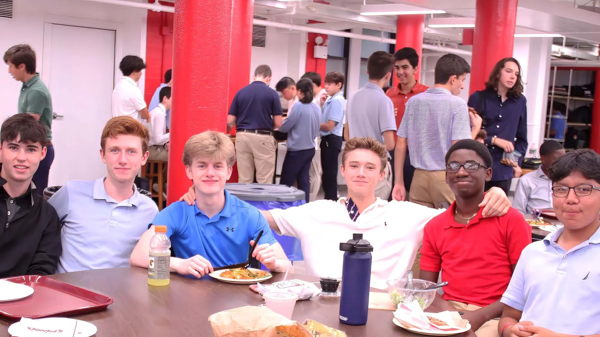Students sitting at table and smiling
