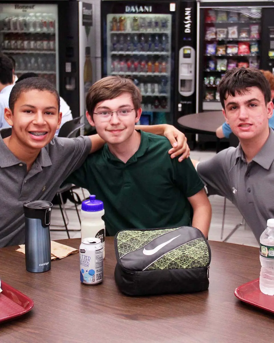 Students sitting at table and smiling